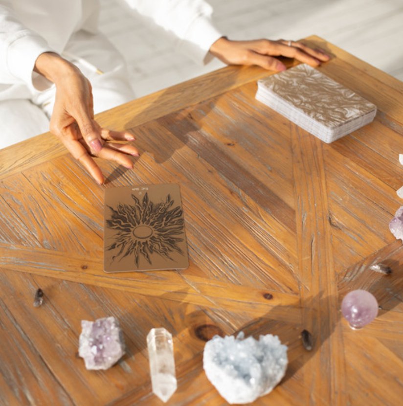 A person holding a tarot card with a mystical glow, symbolizing intuitive insights